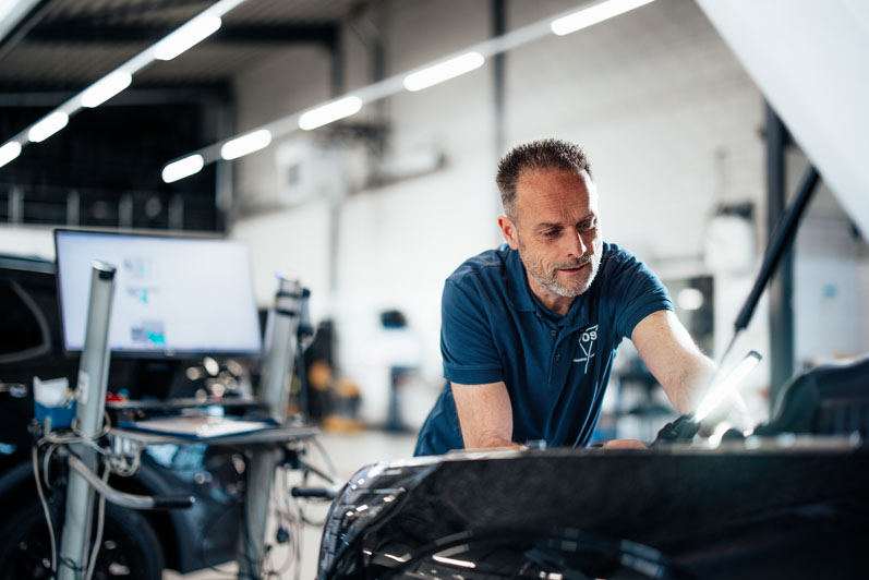 werknemer die helpt bij auto